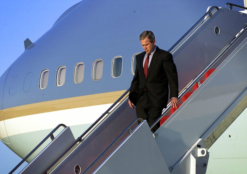 ANDREWS AIR FORCE BASE, MD - SEPTEMBER 11: US President George W. Bush walks down the steps of Air Force One as he arrives at Andrews Air Force Base 11 September 2001 in Maryland. Bush will address the nation from the Oval Office on the terrorist attacks at the World Trade Center and the Pentagon. (Photo credit should read DOUG MILLS/AFP/Getty Images)