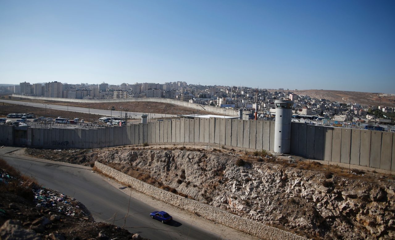 A general view shows a section of Israel's controversial separation wall near Qalandia crossing between the West Bank city of Ramallah and Israel-annexed east Jerusalem on July 28, 2016. The tarmac of the former Atarot airport, which has been closed to civilian traffic since the breakout of the second Palestinian intifada (uprising) in 2000, can be seen in the centre. / AFP / AHMAD GHARABLI (Photo credit should read AHMAD GHARABLI/AFP/Getty Images)