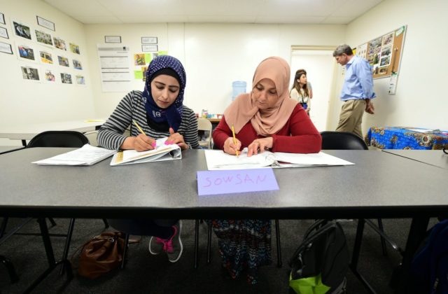 Syrian refugees take notes during their Vocational ESL class at the International Rescue Committee center in San Diego on August 31, 2016. Seated from left to right are: Rawa Hawara and Sousan Alziat. The United States has taken in10,000 Syrian refugees in 2016 as part of a resettlement program that …