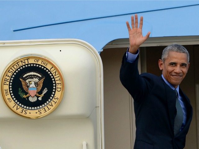 Barack Obama waves as he boards Air Force One following the closing ceremony of the Associ