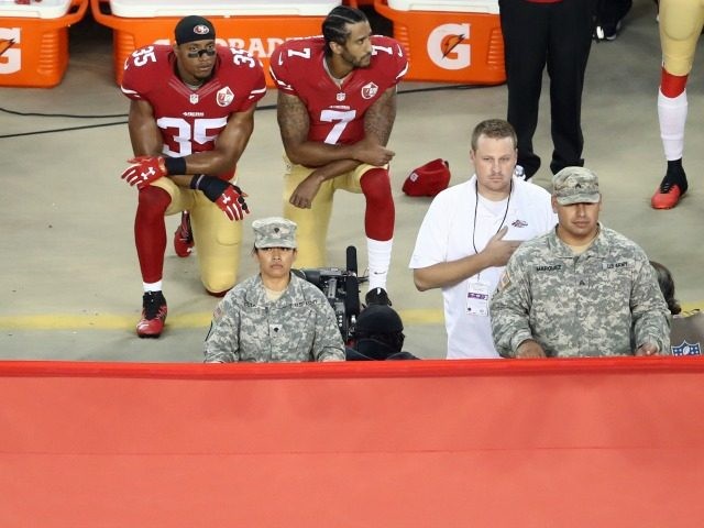 Colin Kaepernick #7 and Eric Reid #35 of the San Francisco 49ers kneel in protest during the national anthem September 12, 2016 in Santa Clara, California.