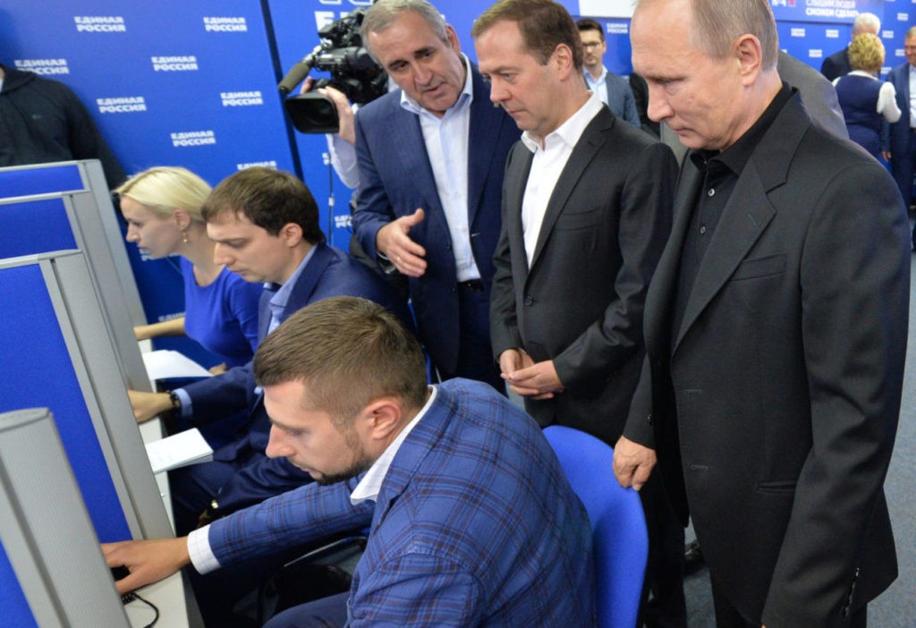 TOPSHOT - Russian President Vladimir Putin (R) and Russian Prime Minister and chairman of the United Russia political party Dmitry Medvedev (2R) visit the party's election campaign headquarters during parliamentary elections in Moscow on September 18, 2016. Russia's ruling party won 49.8 percent of the vote in nationwide legislative elections, partial results showed, as it is set to dominate a new parliament made up of Kremlin loyalists. / AFP / SPUTNIK / Alexei Druzhinin        (Photo credit should read ALEXEI DRUZHININ/AFP/Getty Images)
