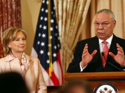 Former U.S. Secretary of State Colin Powell (R) speaks with U.S. Secretary of State Hillar