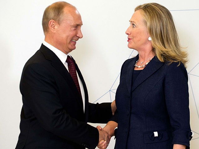 U.S. Secretary of State Hillary Rodham Clinton, right, is greeted by Russian President Vladimir Putin during the arrival ceremony for the Asia-Pacific Economic Cooperation (APEC) Summit in Vladivostok, Russia, Saturday, Sept. 8, 2012. (AP Photo/Jim Watson, Pool)