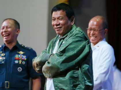 Philippine President Rodrigo Duterte wears a pilot's jacket which was presented to him during his "Talk with the Airmen" on the anniversary of the 250th Presidential Airlift Wing Tuesday, Sept. 13, 2016 at the Philippine Air Force headquarters in suburban Pasay city, southeast of Manila, Philippines. On Monday, President Duterte, …