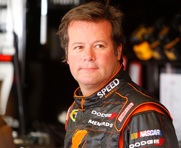 Sprint Cup driver Robby Gordon stands in the garage area amid practice for the upcoming Sa