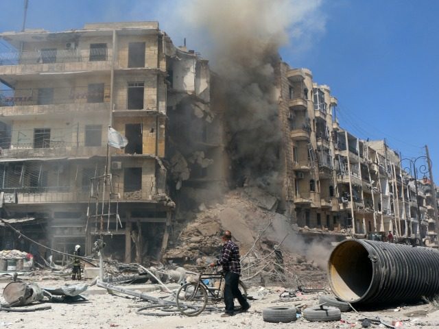 A man walks past the rubble of a building following reported shelling by Syrian government