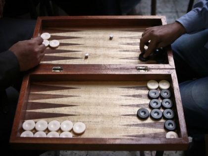 Egyptians play backgammon at a cafe in Cairo on November 24, 2014. Six months after Abdel Fattah al-Sisi became Egypt's president a deadly crackdown on Islamist supporters of Sisi's predecessor Mohamed Morsi, whom he ousted last year has generated a climate of fear at train and bus stations, public squares …