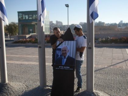 JERUSALEM, ISRAEL - SEPTEMBER 29: Israeli workers prepare a Picture of former Israeli Pre