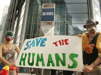 LONDON, ENGLAND - SEPTEMBER 01: Climate change protesters hold a banner as they stand at the entrance to The Royal Bank of Scotland's headquarters on September 1, 2009 in London, England. Climate campaigners have also been staging a week long protest camp in Blackheath south London. (Photo by Peter Macdiarmid/Getty …
