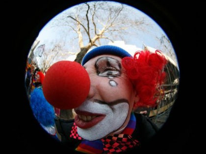 A carnival reveller dressed as a clown celebrates on the street in Berlin February 18, 200