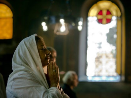 An Egyptian Coptic Christian prays during a service for the departed remembering the victi