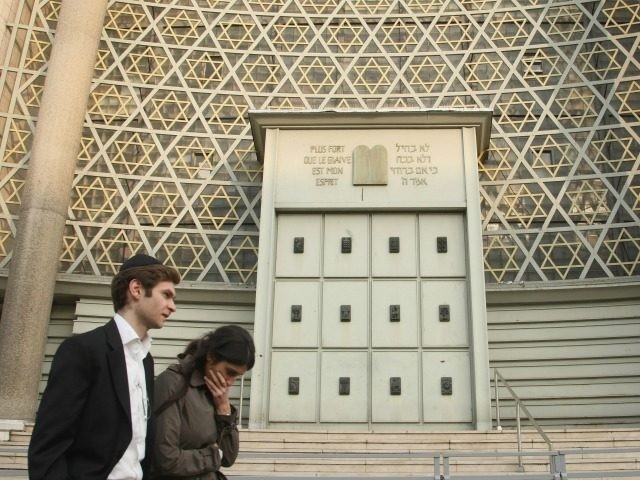 STRASBOURG, FRANCE - APRIL 04: A young Jewish couple walk past the Synagogue de la Paix synagogue April 4, 2009 in Strasbourg, France. Strasbourg is home to approximately 16,000 Jews, including a flourishing Orthodox Jewish community. (Photo by Sean Gallup/Getty Images)