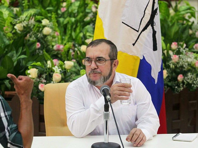 FARC rebel leader Rodrigo Londono (R), better known by the nom de guerre Timochenko, speaks to a man during a news conference after his meeting with Colombia's President Juan Manuel Santos and Cuba's President Raul Castro in Havana September 23, 2015. REUTERS/Stringer