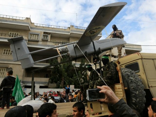 Palestinian militants of the Ezzedine al-Qassam Brigades, Hamas' armed wing, dislpay a drone during a parade marking the 27th anniversary of the Islamist movements creation on December 14, 2014 in Gaza City. AFP PHOTO / MAHMUD HAMS (Photo credit should read MAHMUD HAMS/AFP/Getty Images)