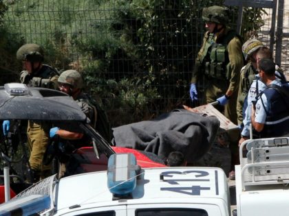 Israeli security forces evacuate a wounded Palestinian, who was shot during a reported sta