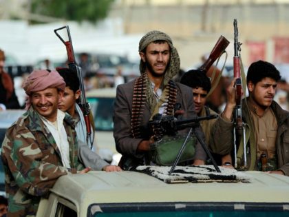 Armed tribesmen, loyal to the Shiite Houthi rebels, stand in the back of a vehicle as they attend a gathering in the capital Sanaa to mobilize more fighters to battlefronts to fight pro-government forces in several Yemeni cities, on June 20, 2016. The Shiite Huthi rebels and their allies overran …