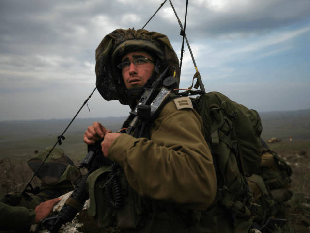 GOLAN HEIGHTS - DECEMBER 10: Israeli army paratroopers advance as their brigade completes