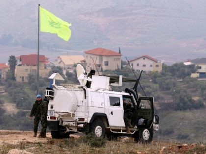 Soldier of the United Nations Interim Forces in Lebanon (UNIFIL) monitor the area in the Lebanese town of Marjayoun on border with Israel, as the Israeli village of Mutella is seen in the background, on January 5, 2016, one day after the Israeli army shelled the area in retaliation to …