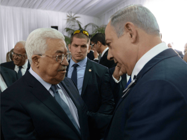 In this handout photo provided by the Israel Government Press Office (GPO), Israeli Prime Minister Benjamin Netanyahu shakes hands with Palestinian Authority President Mahmoud Abbas during the funeral of former Israeli leader Shimon Peres on September 30, 2016 in Jerusalem, Israel. World leaders and dignitaries from 70 countries attended the …
