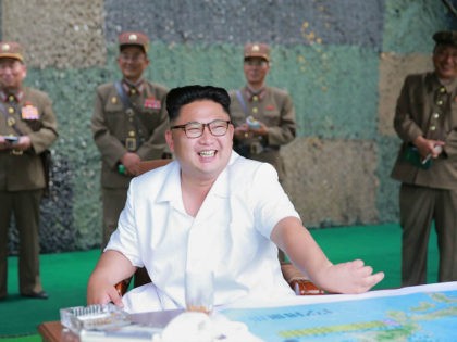 This undated photo released by North Korea's official Korean Central News Agency (KCNA) on July 21, 2016 shows North Korean leader Kim Jong-Un (C) smiling as he visits a drill for ballistic missile launch by the Hwasong artillery units of the Strategic Force of the Korean People's Army. North Korea …