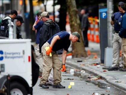 Evidence teams investigate at the scene of Saturday's explosion on West 23 Street in Manha