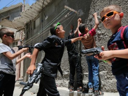 Palestinian children play with toy guns in the southern Gaza Strip town of Rafah on July 7, 2016, on the second day of Eid al-Fitr holiday, which marks the end of the holy Muslim month of Ramadan. / AFP / SAID KHATIB (Photo credit should read SAID KHATIB/AFP/Getty Images)