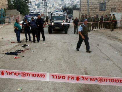 Israeli security forces gather at the scene of a stabbing attack, where a Palestinian stabbed an Israeli soldier before he was shot dead, in the flashpoint West Bank city of Hebron on September 17, 2016. An Israeli military statement said the attacker drew a knife during a routine security check …