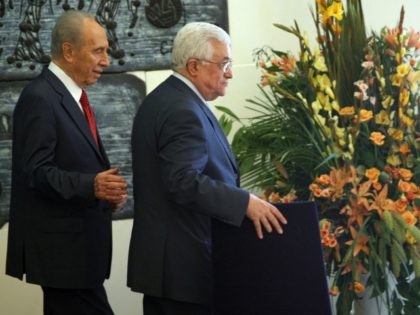 Israeli President Shimon Peres (L) walks with Palestinian Authority President Mahmud Abbas at the end of a joint press conference at the president's residence in Jerusalem on July 22, 2008. Abbas and Peres met to review developments in the peace process between the two sides. AFP PHOTO/MENAHEM KAHANA (Photo credit …