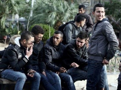 Migrants men sit on a bench on March 3, 2016 at the Victoria square in central Athens, where hundreds of migrants and refugees stay temporarily. Athens said on March 3, 2016 it now had nearly 32,000 migrants on its territory, after Austria and Balkan states began restricting entries, creating a …