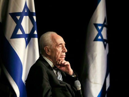 FILE - In this Sunday, July 6, 2014, file photo, Israeli President Shimon Peres talks duri