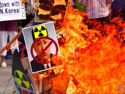 South Korean conservative activists set fire to a portrait of North Korean leader Kim Jong-Un during a protest denouncing North Korea's nuclear test in Seoul on September 10, 2016. South Korean newspapers sounded the alarm on September 10 over what one termed the 'nuclear maniac' Kim Jong-Un, saying the North …