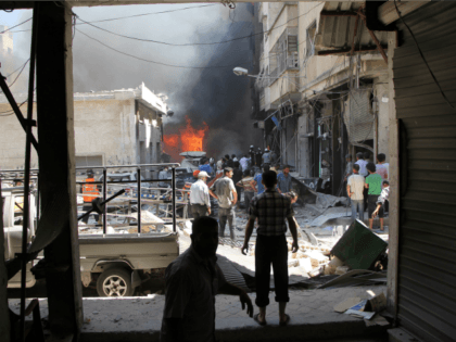 Graphic content / Syrian men search for victims at the scene of a reported air strike on t
