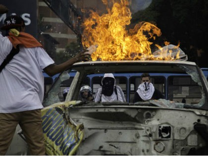 Protesters set a truck on fire on the Francisco Fajardo highway during protests in Caracas