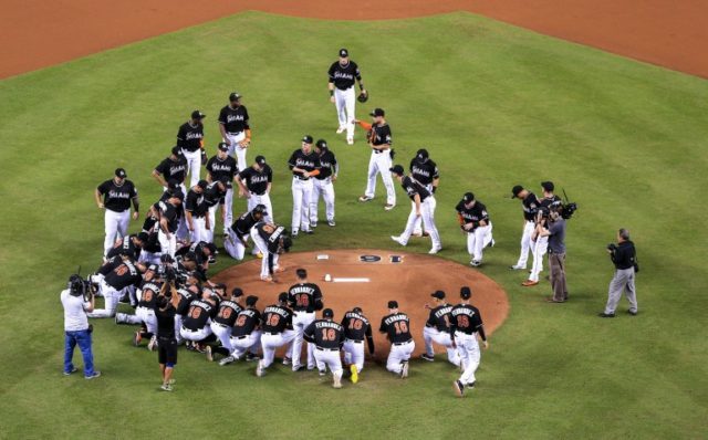Miami Marlins players all wearing jerseys bearing the number 16 and name Fernandez honor t