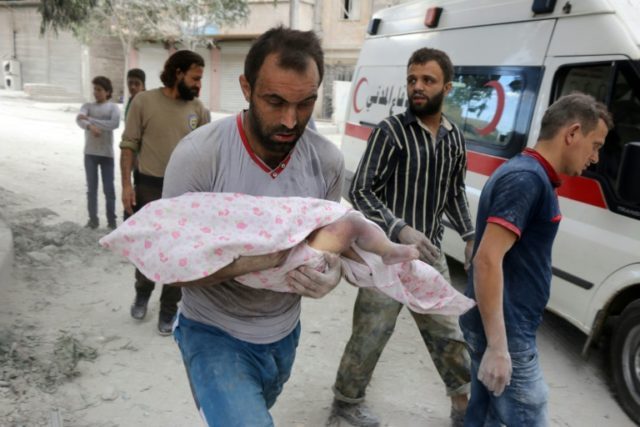 A Syrian man carries the body of an child retrieved from under the rubble of a building fo