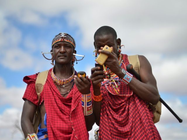 Kenyan Maasai 'Morans' (warriors) relay the GPS coordinates of the location of two-young l