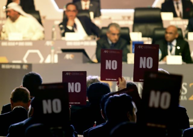 AFC members hold up 'NO' voting cards during the AFC Extraordinary Congress in Goa
