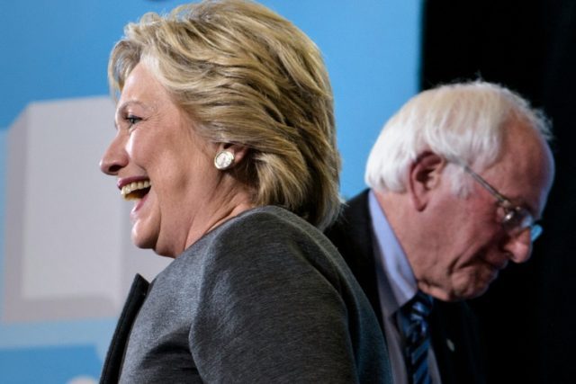 Former Democratic primary rivals Hillary Clinton (L) and Bernie Sanders teamed up in a bid