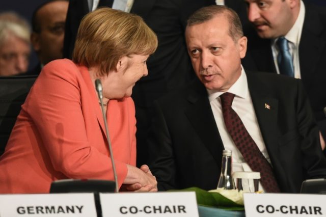 German Chancellor Angela Merkel (left) shakes hands with Turkish President Recep Tayyip Er