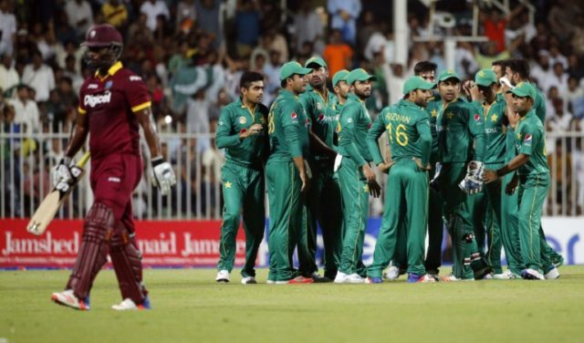 Pakistan's players celebrate after bowling out West Indies' batsman Johnson Charles (L) du