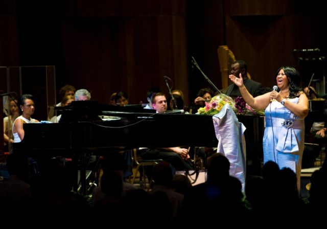 Aretha Franklin (R) and Condoleezza Rice (L) are seen performing with the Philadelphia Orc