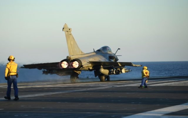 A French Rafale fighter jet is readied for take-off from the French aircraft carrier Charl