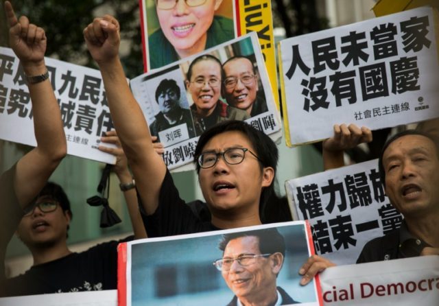 A small group of protesters led by rebel lawmaker Leung Kwok-hung (C) gathered outside the