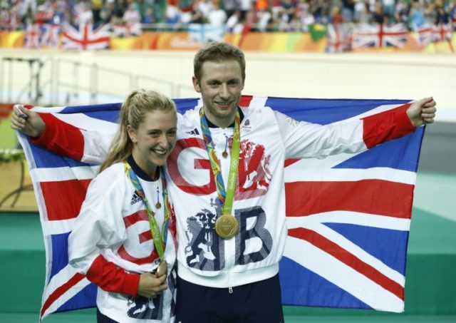 Gold medallist Britain's Jason Kenny (R) poses next to Women's Omnium gold medallist Brita