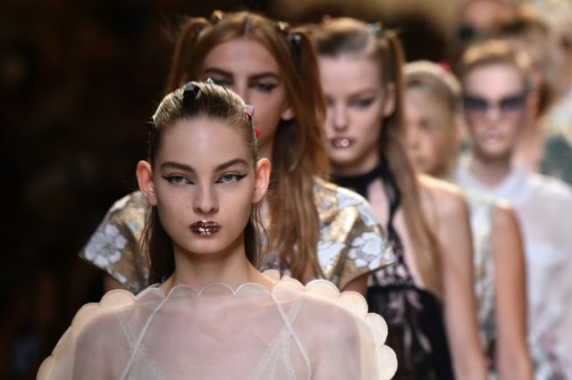 Models pouted their glitter-coated lips to highlight a look that Lagerfeld revealed had be