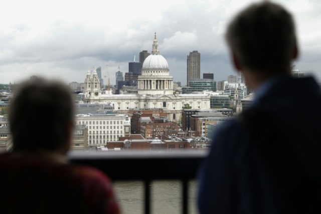 Visitors look at St Paul's Cathedral across the river Thames from the balcony of the new S