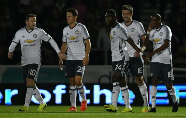 Manchester United's Michael Carrick (2nd R) celebrates scoring a goal with teammates durin
