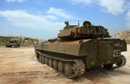 Syrian government tank patrols the town of Khan Tuman, south of Aleppo