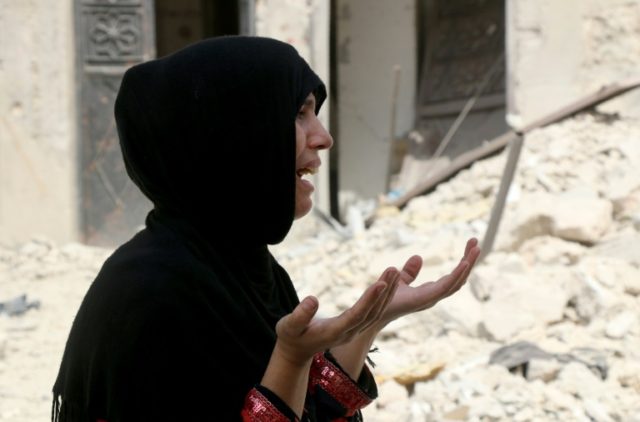 A woman after a reported barrel bomb attack in Bab al-Nairab, a neighbourhood of Aleppo in